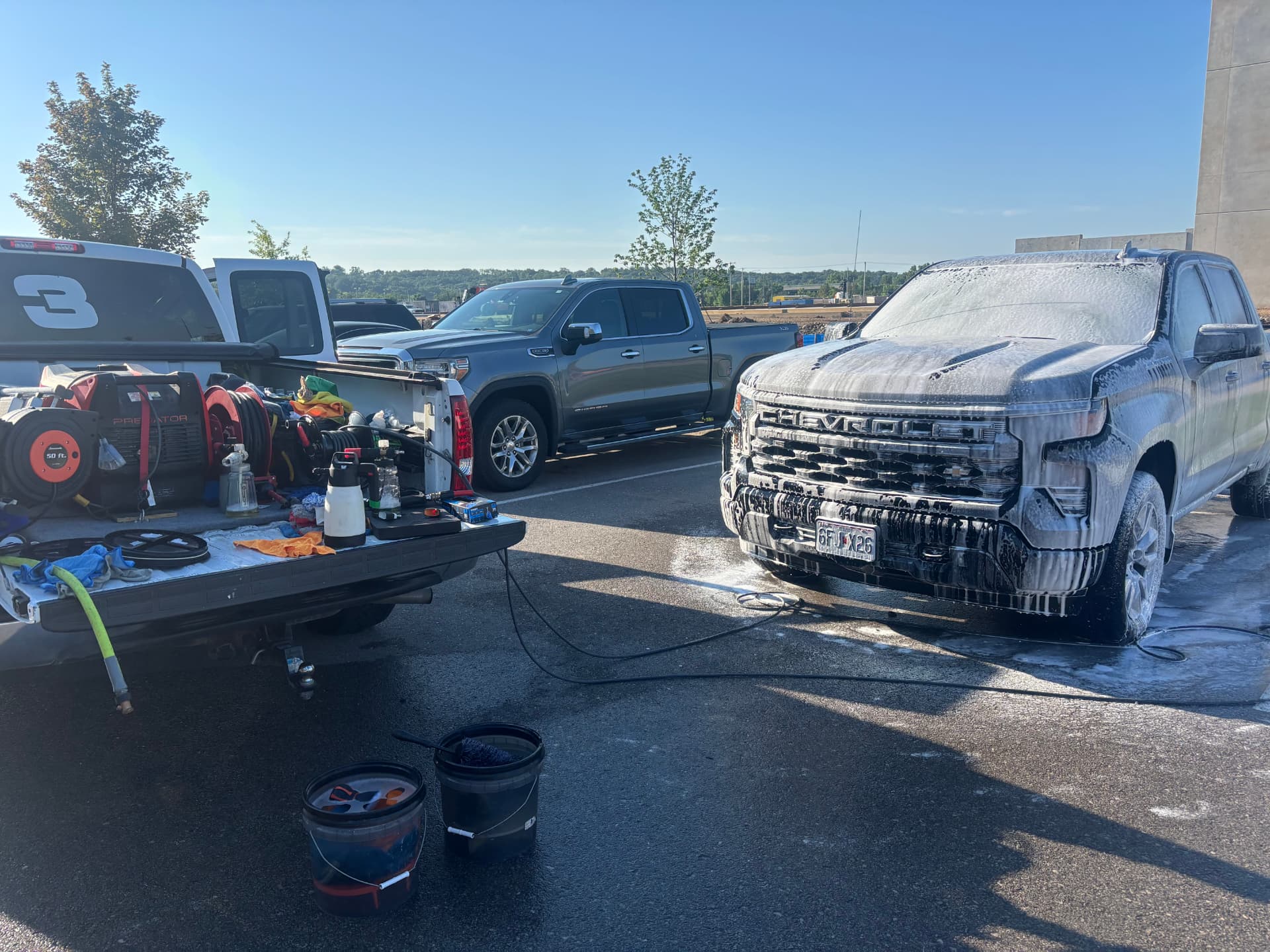 Prestige Auto Detail foaming a Chevrolet Silverado on-site with the full mobile setup
